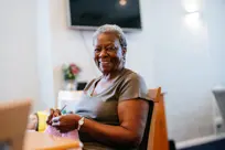 Tenant knitting and smiling