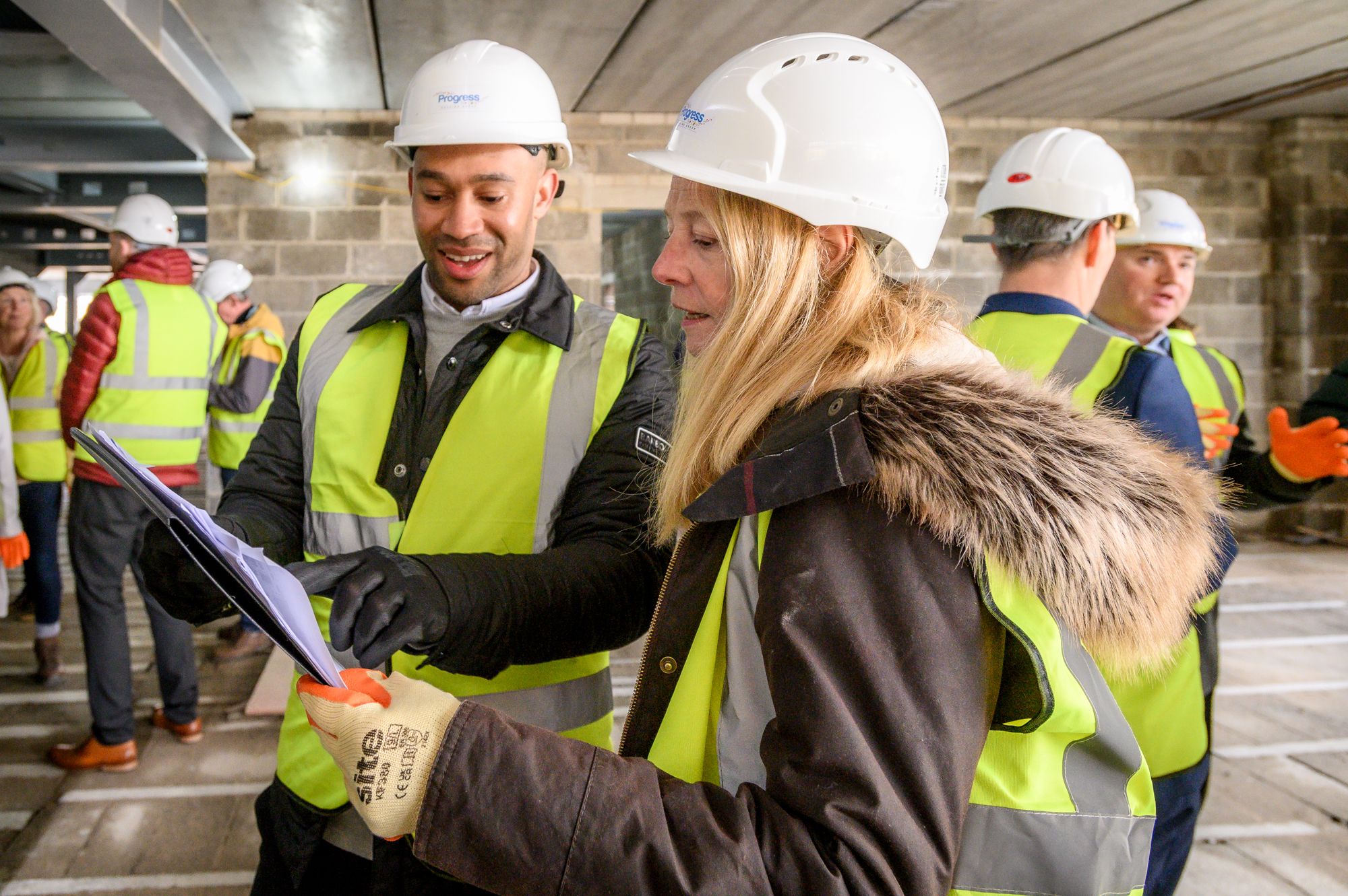 Two people look at a development plan