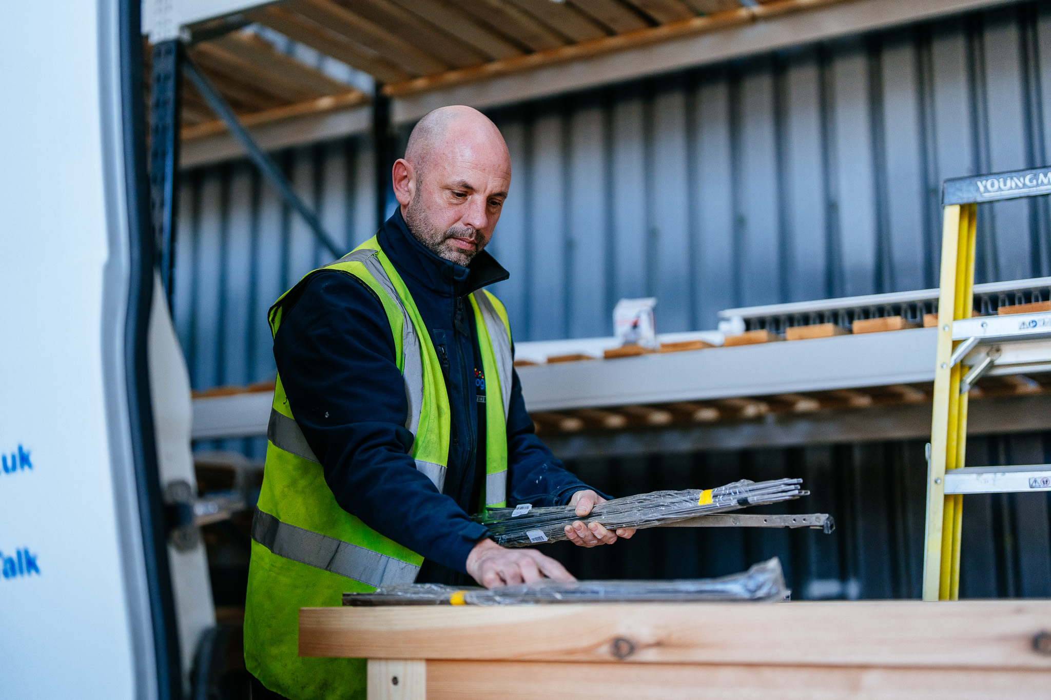 Progress Housing trades person organising materials in warehouse storage unit
