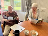 Image of a man and woman reading a leaflet