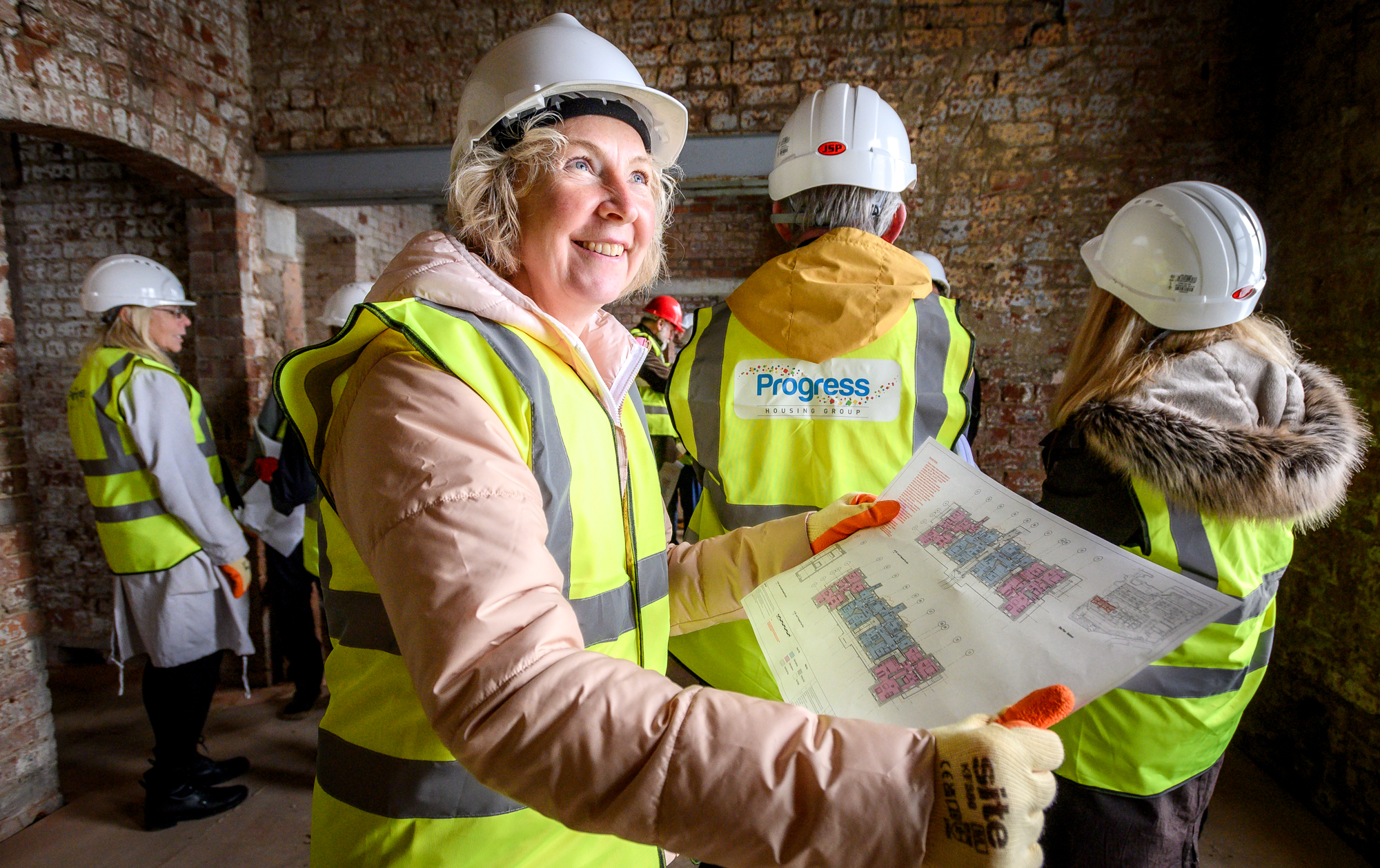 An image of a lady looking at a building plan