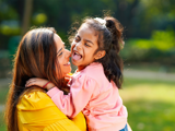 Image of mother holding her young daughter