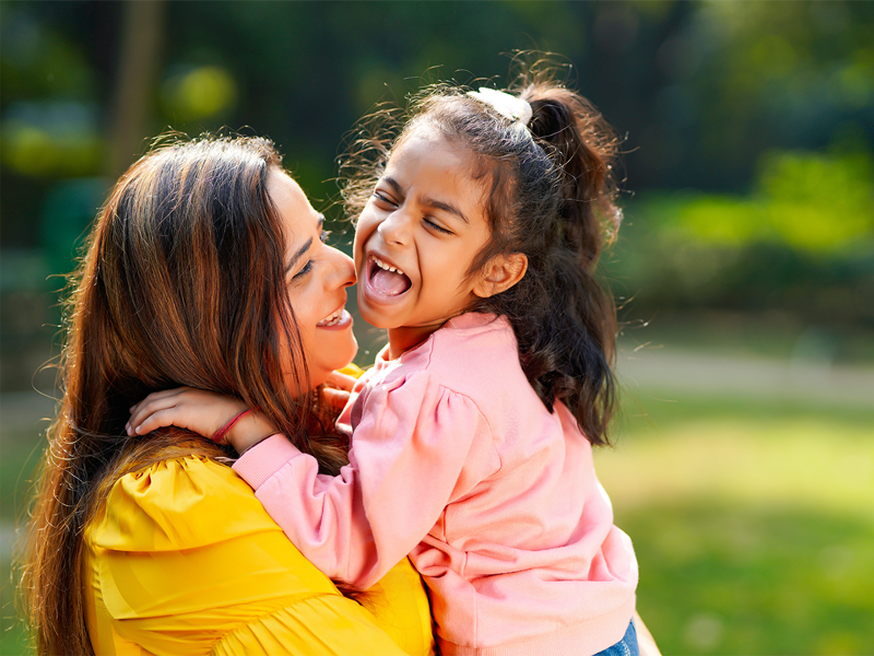Image of mother holding her young daughter