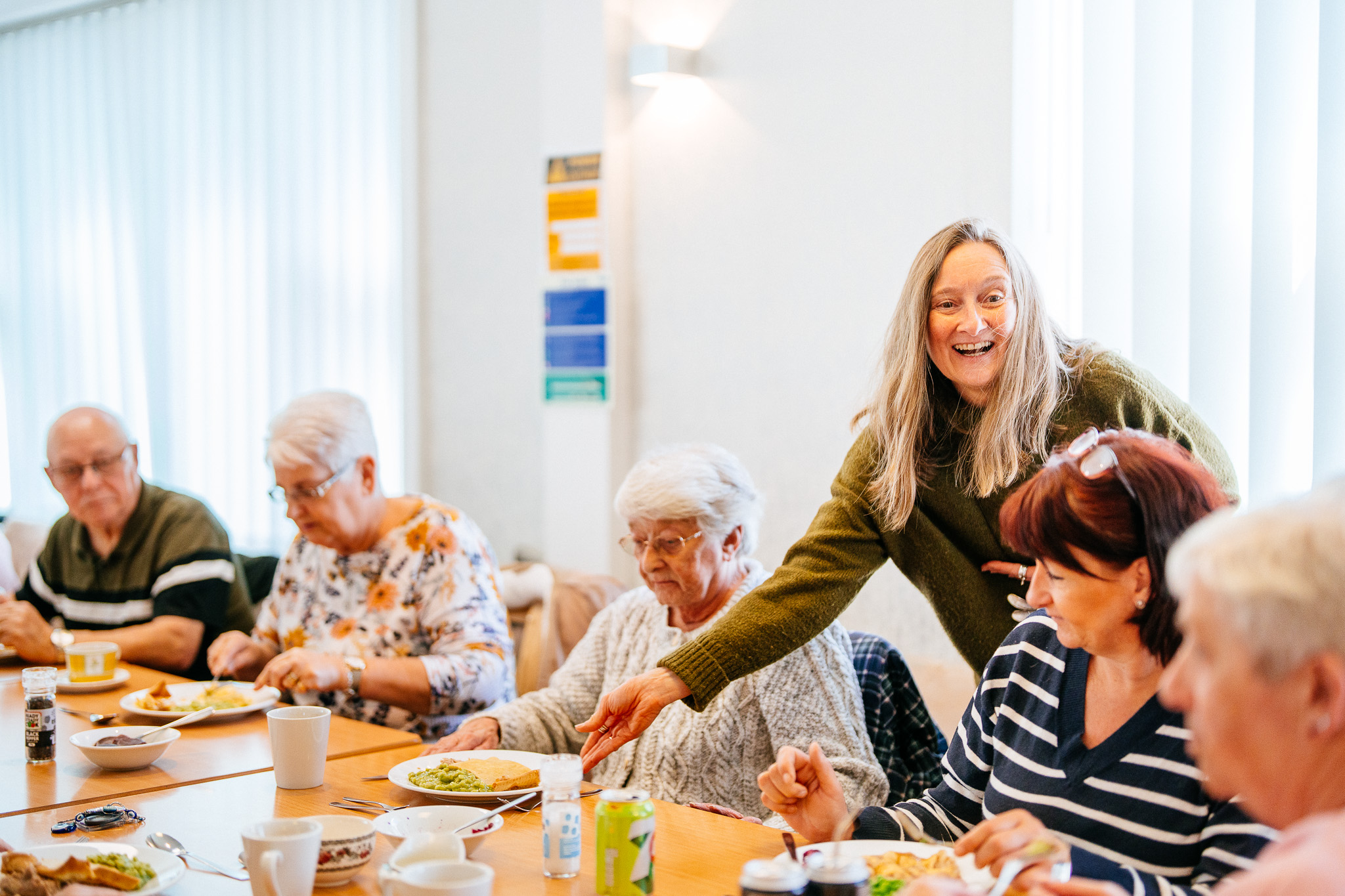 Progress team member serving pie and peas to tenants at a community event