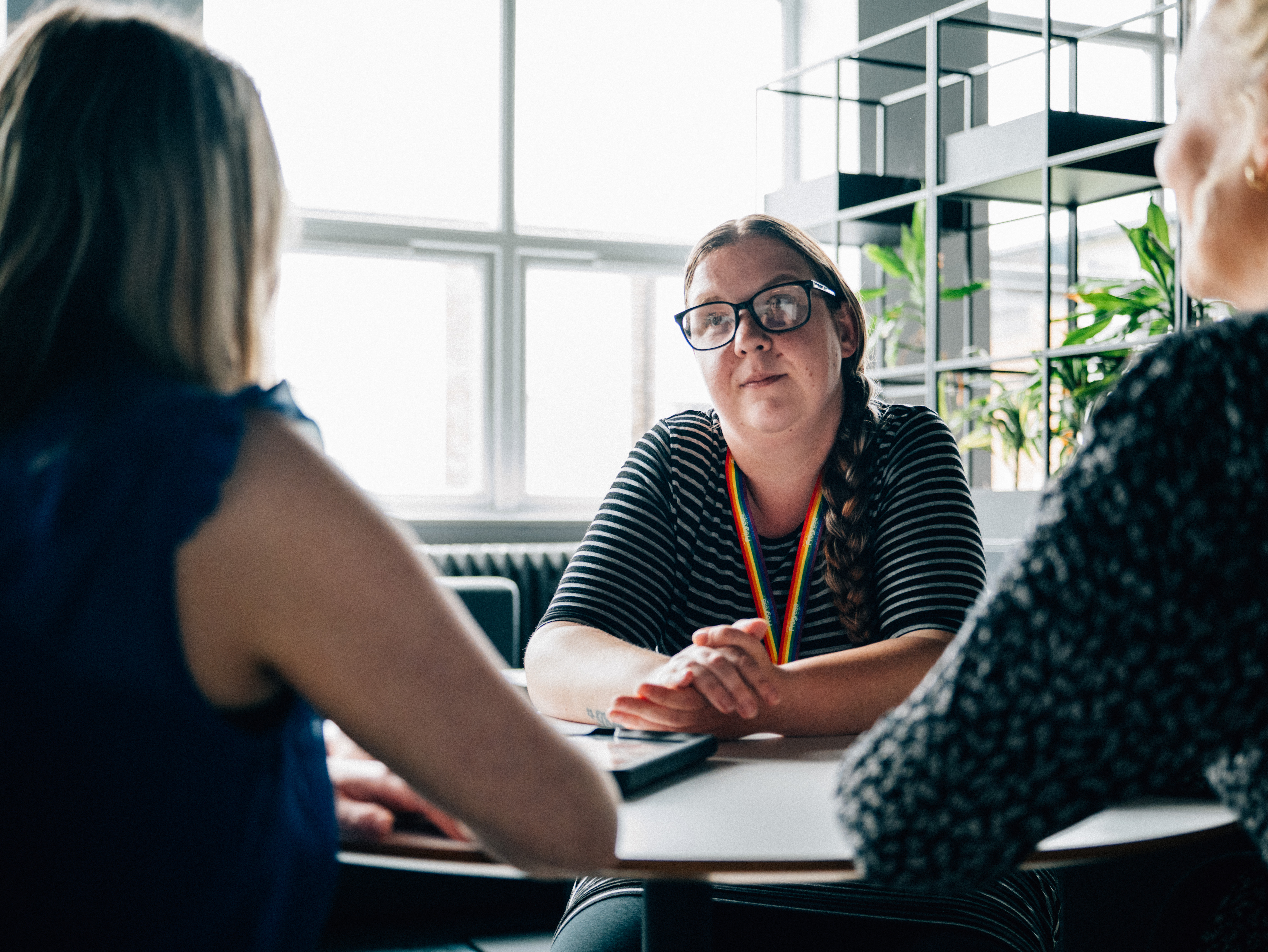 An Image of a three people in a meeting