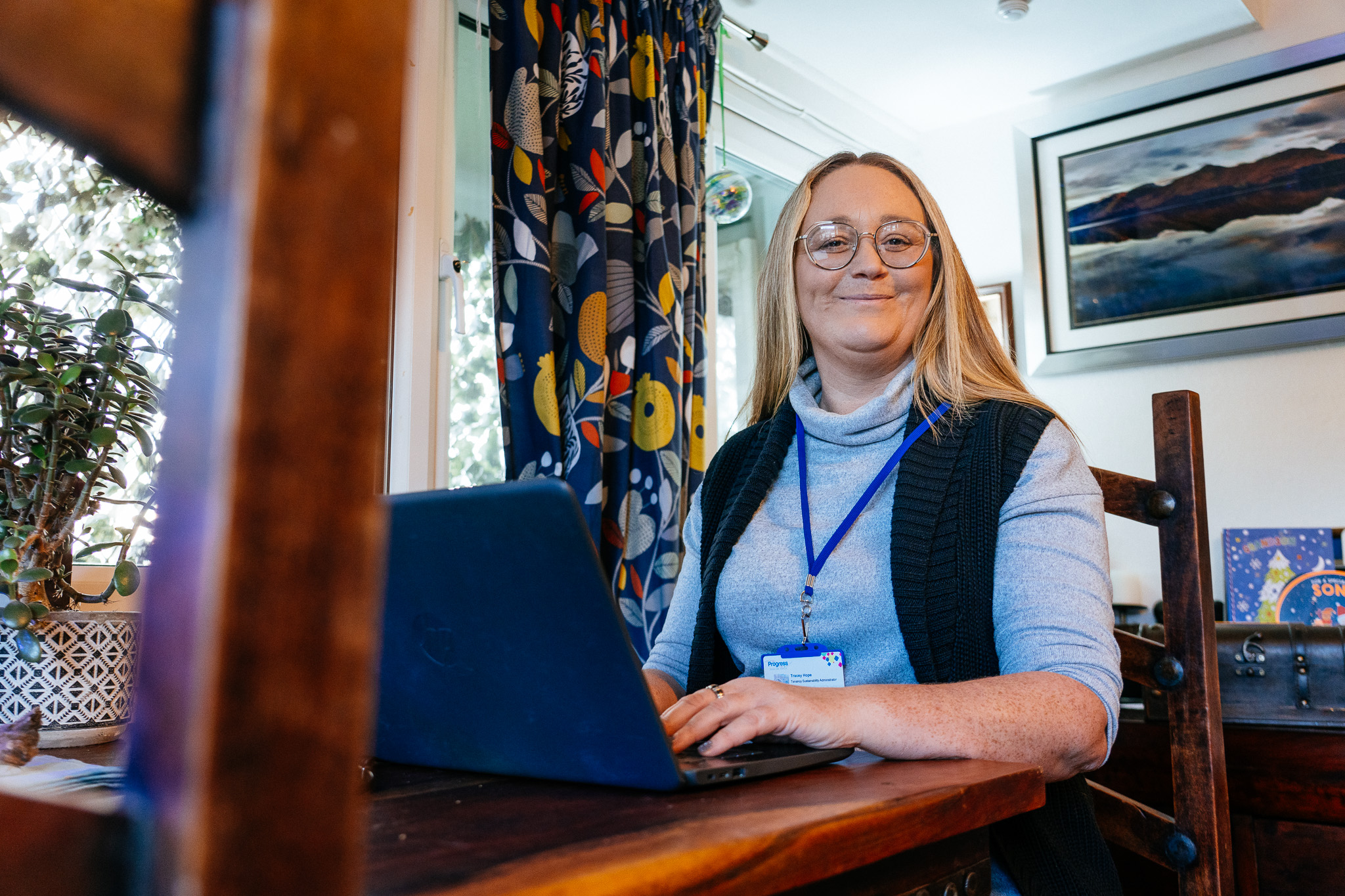 Tracy from the Brighter Futures Team smiling while working on her laptop.