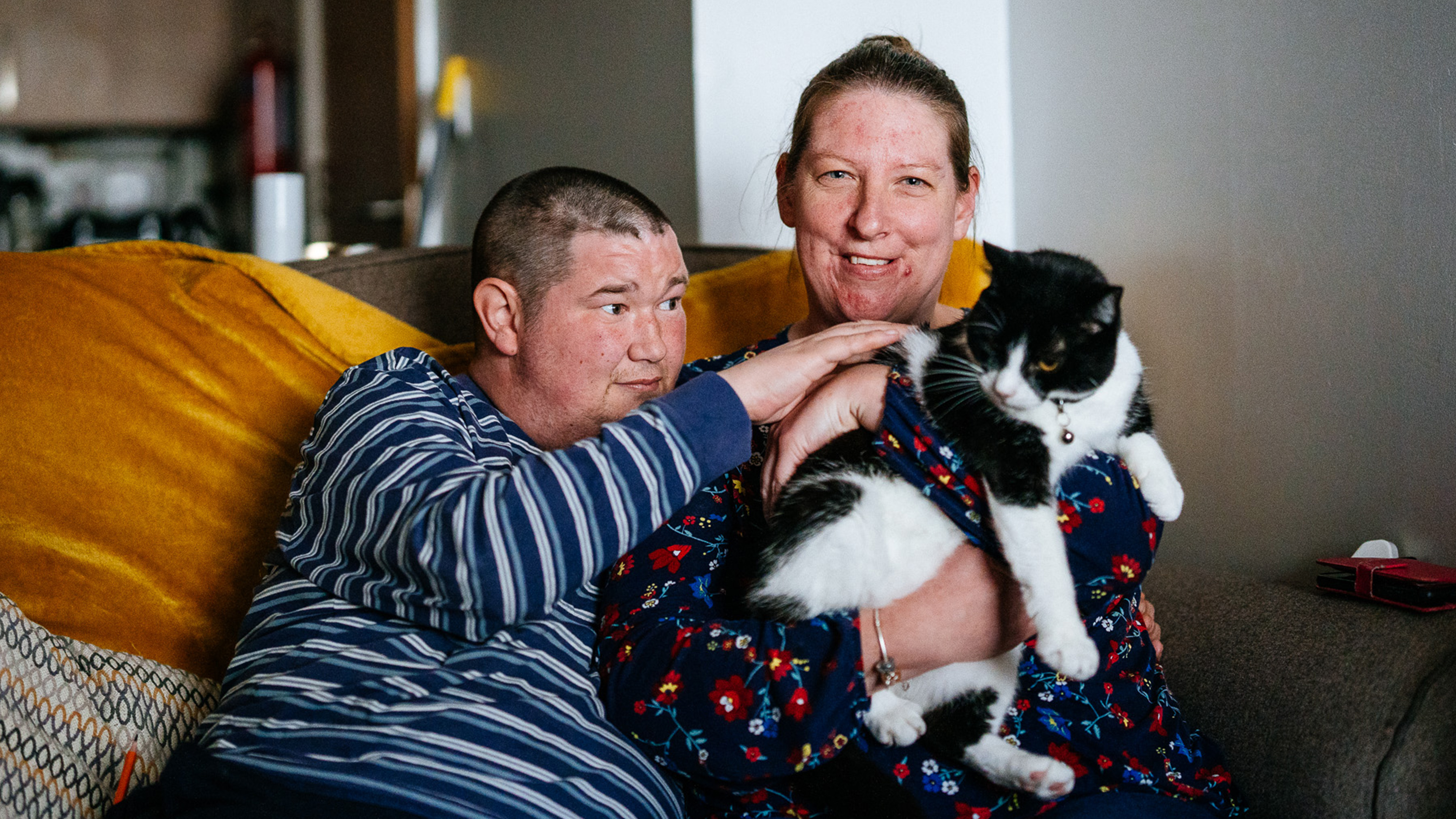 Two RWP tenants holding a cat