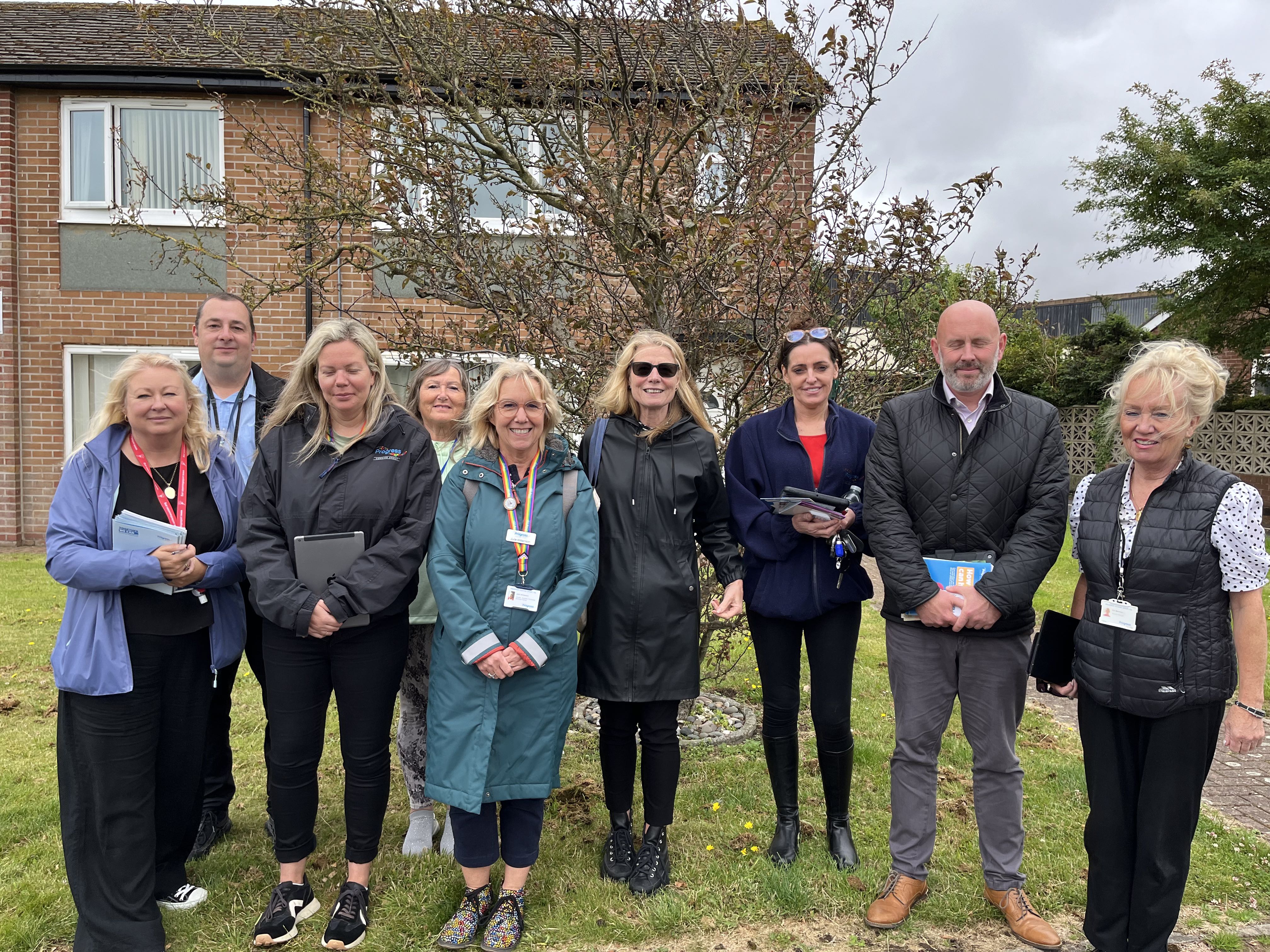 Progress housing board member and team stood in front garden