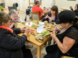 Image of people doing arts and crafts round a table