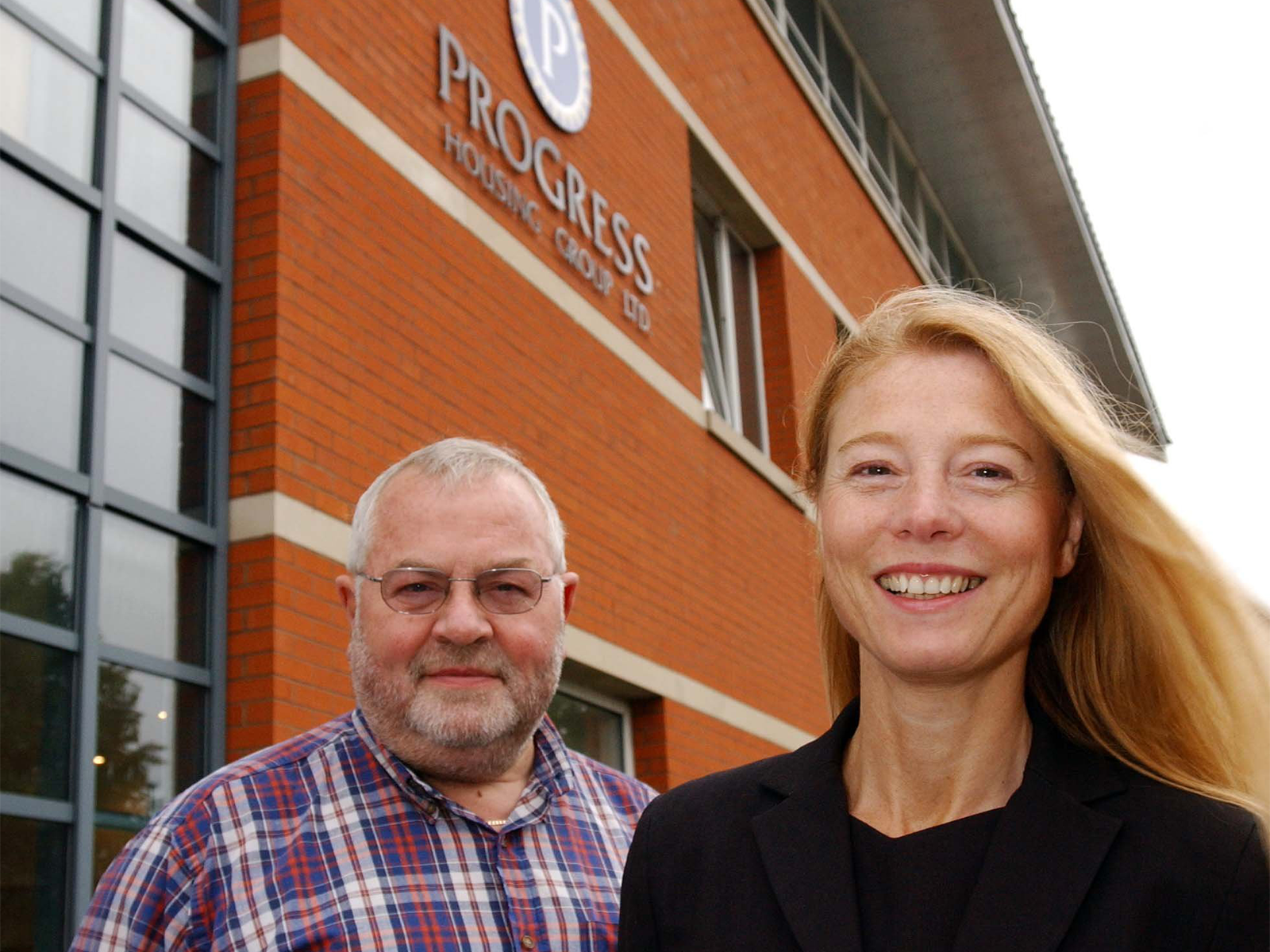 Jacqui Russell in front of Progress housing building