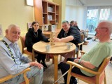 Image of a group round a table playing Jenga