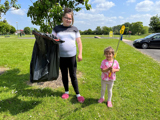 Image of 2 young girls cleaning up park