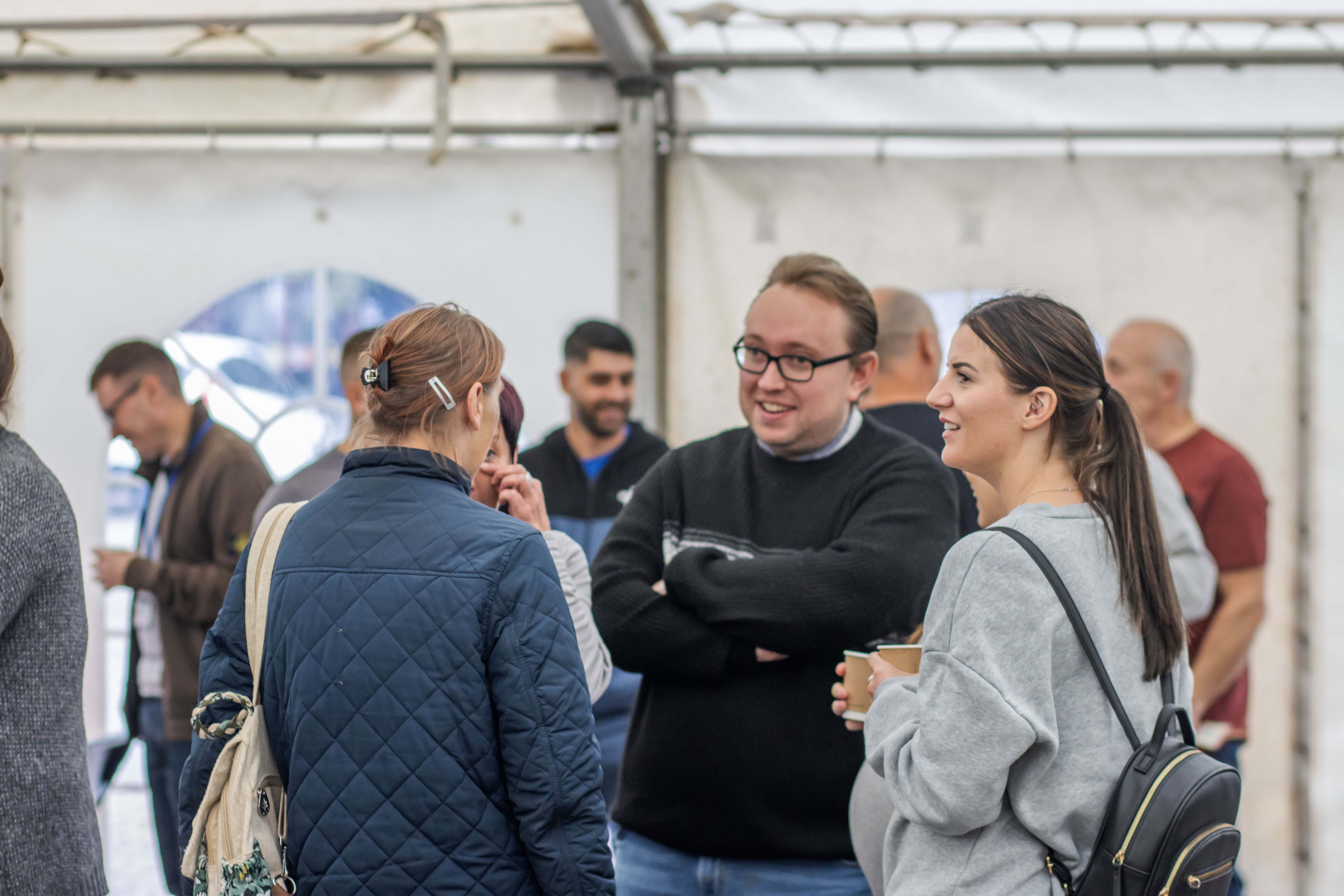 people falking at flower bowl tent event