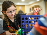 Image of girl playing connect 4