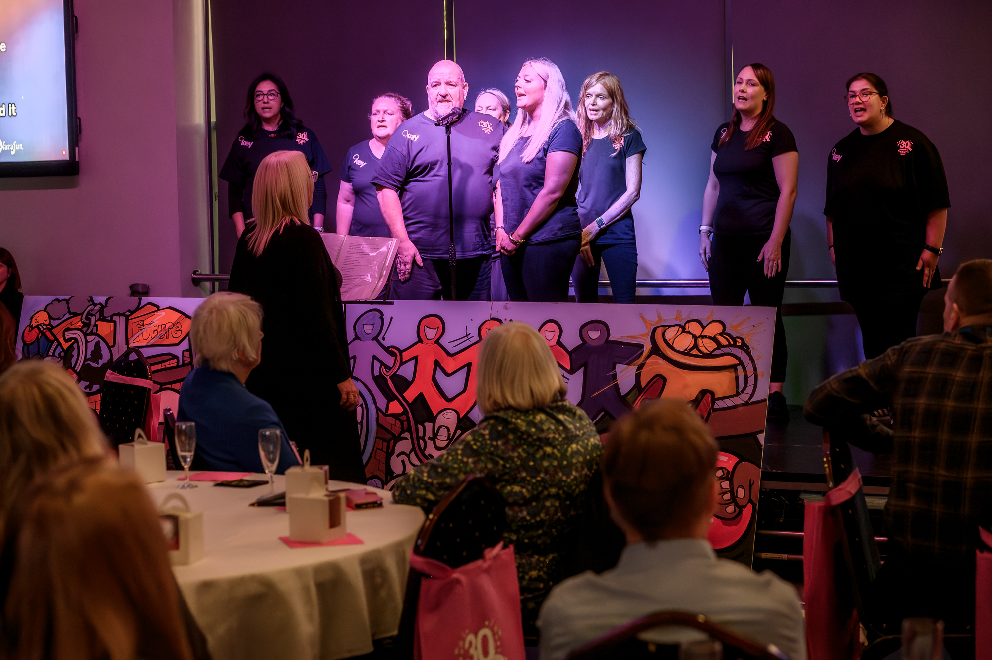 Choir performing at Key’s 30th celebration event, marking resilience and community spirit.