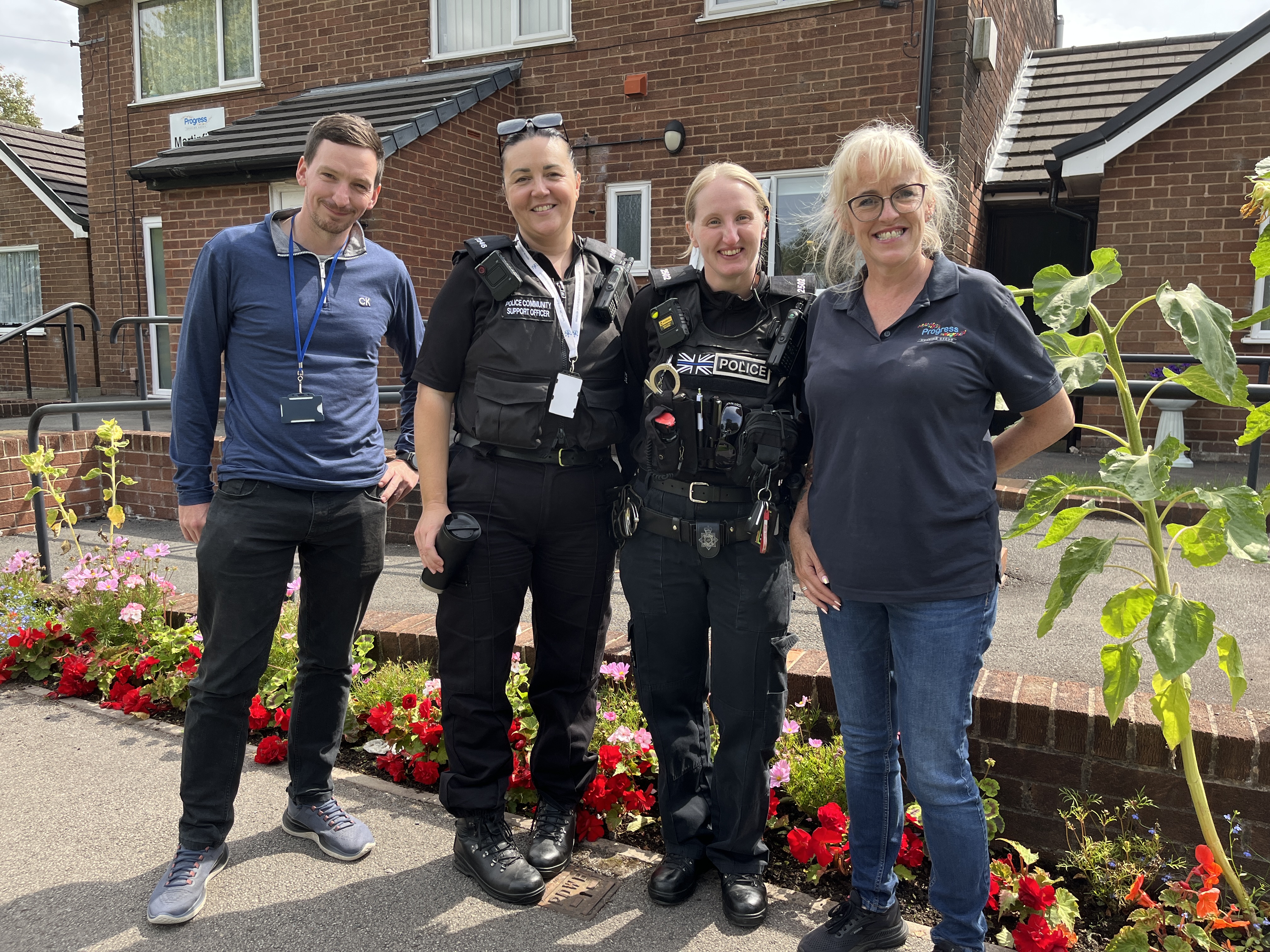 Two police officers stood smiling with two Progress colleagues