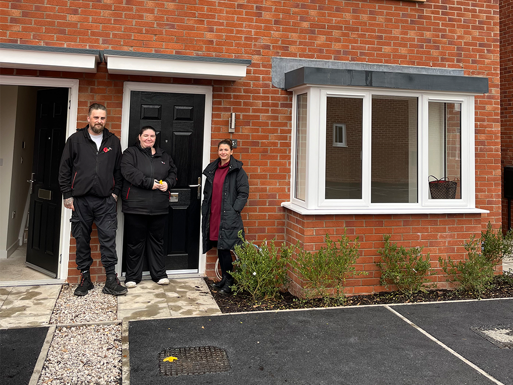 Mr and Mrs Cartwright receiving keys to their new home from area housing manager