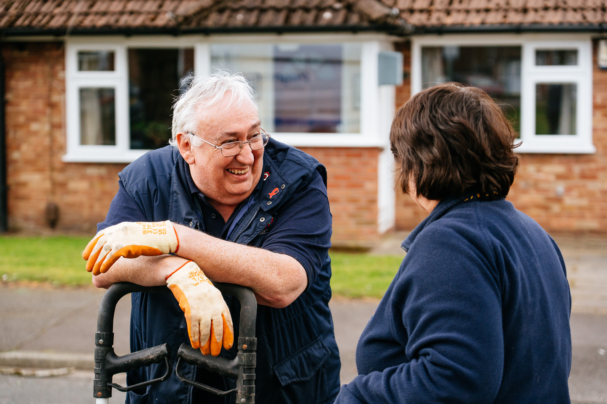Caretaker and Progress team member smiling and chatting on the estate