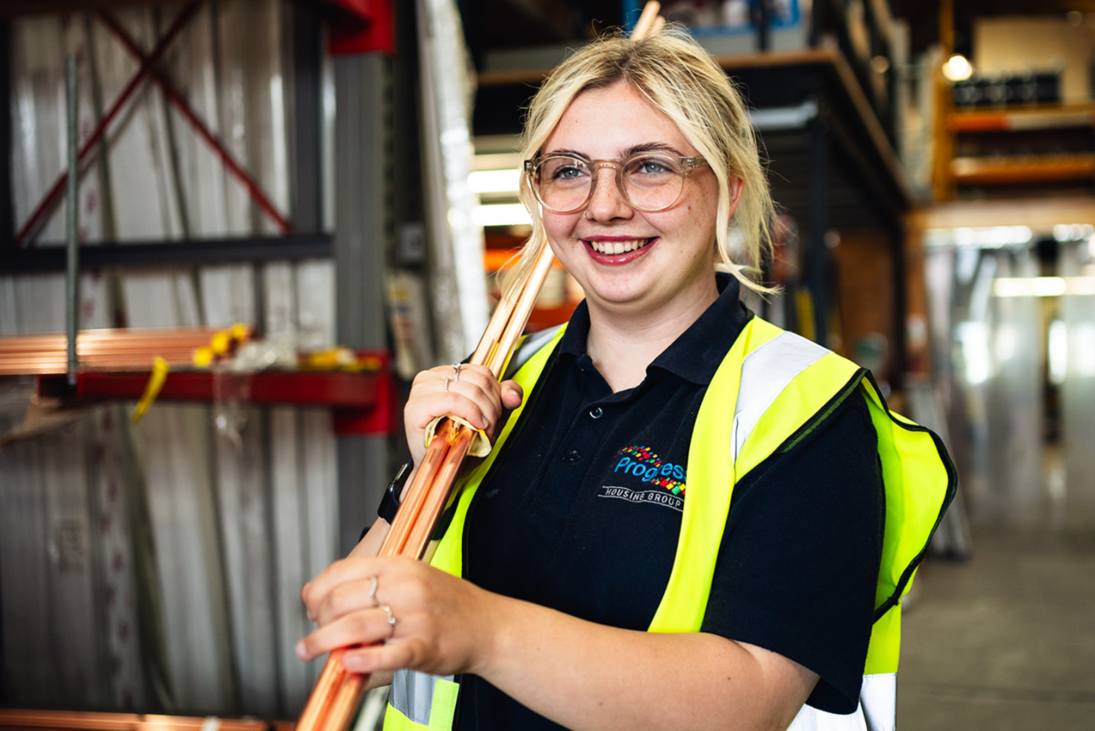 An image of a trades operative carrying piping