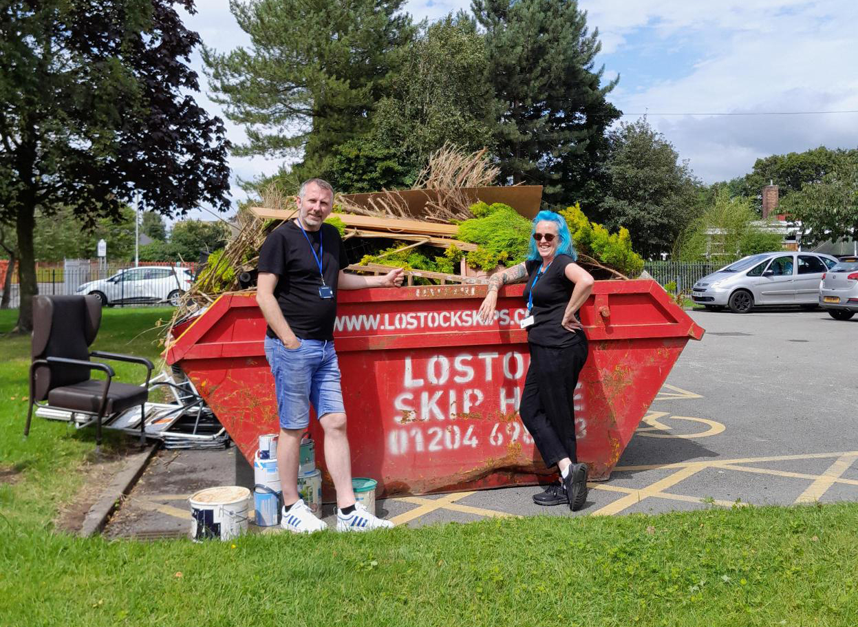 Volunteers and tenants participating in a community clean-up event at Martinfield.
