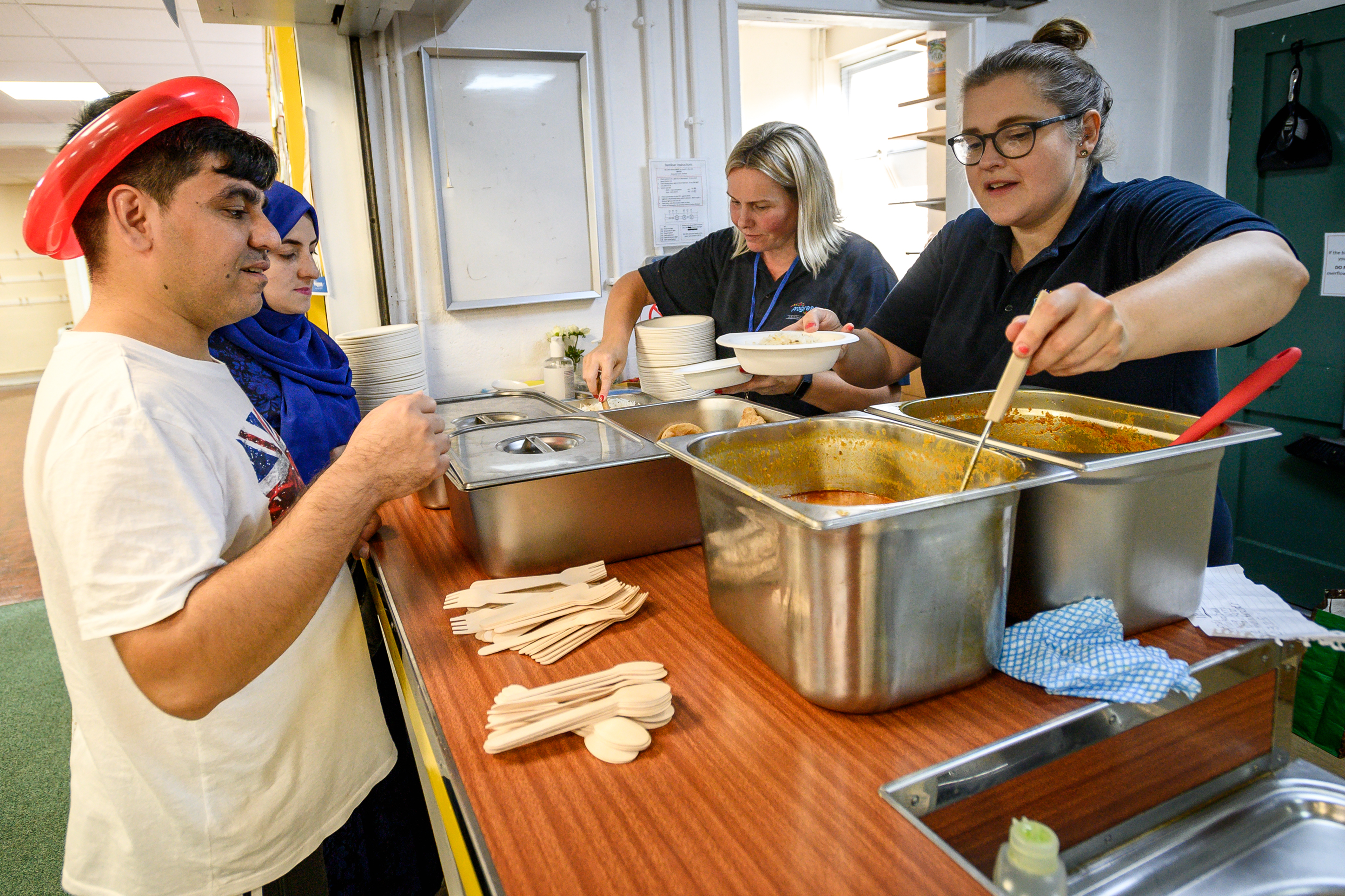 An image of colleagues serving food at the Cultural and Community Celebration event